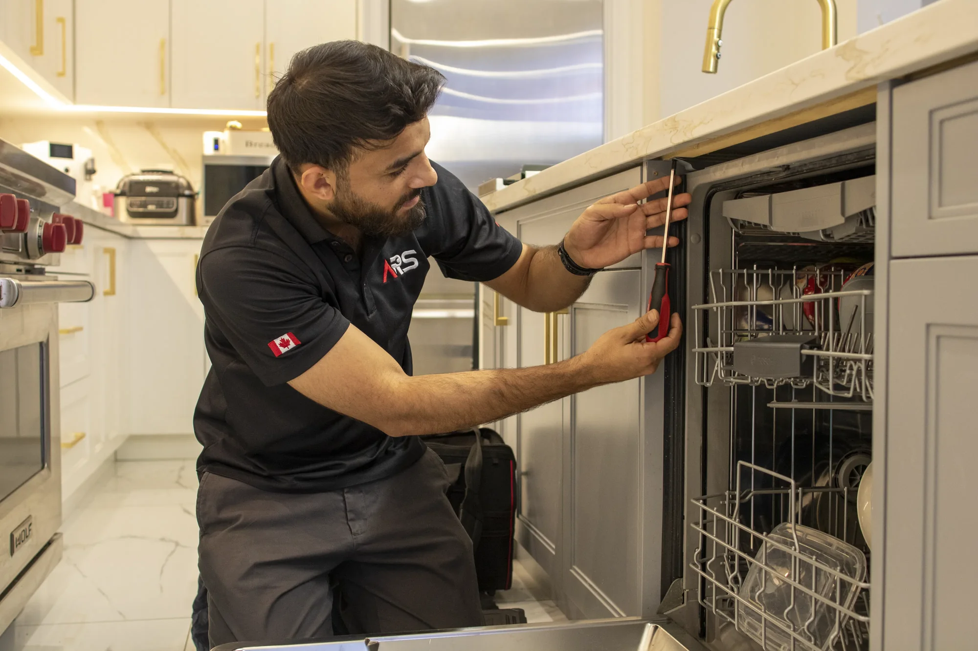 Emergency dishwasher repair technician working in kitchen Emergency dishwasher repair technician working in kitchen