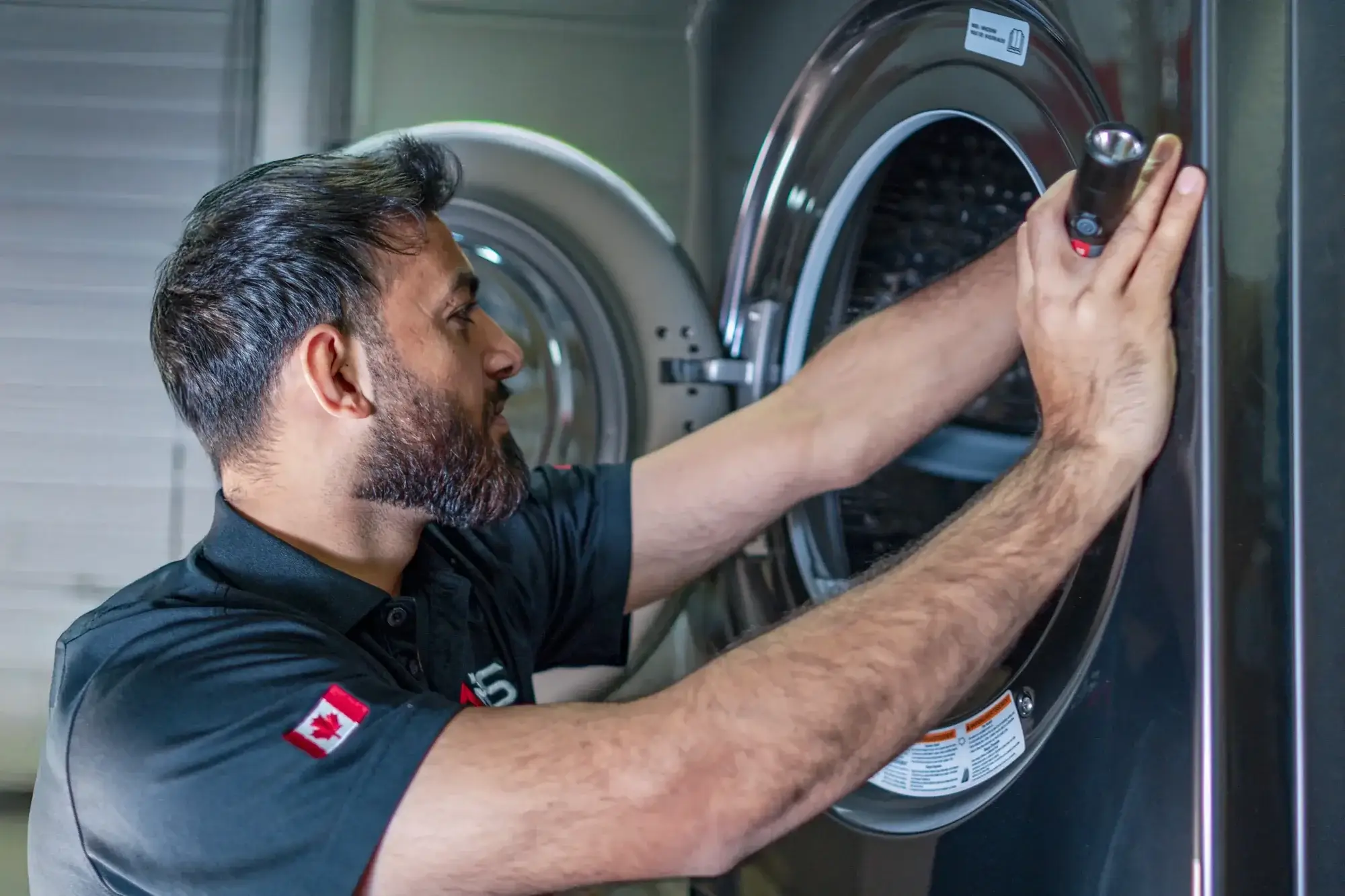 Emergency dryer repair technician performing service Emergency dryer repair technician performing service
