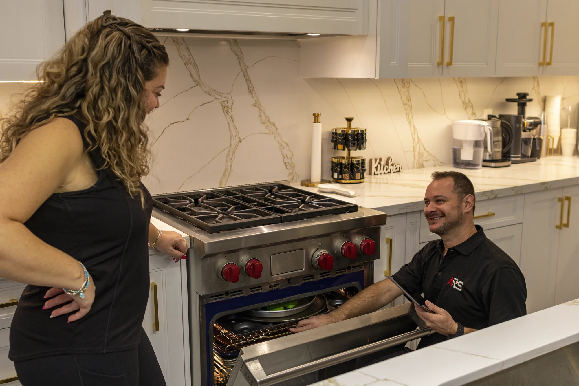 Technician repairing oven heating system Technician repairing oven heating system