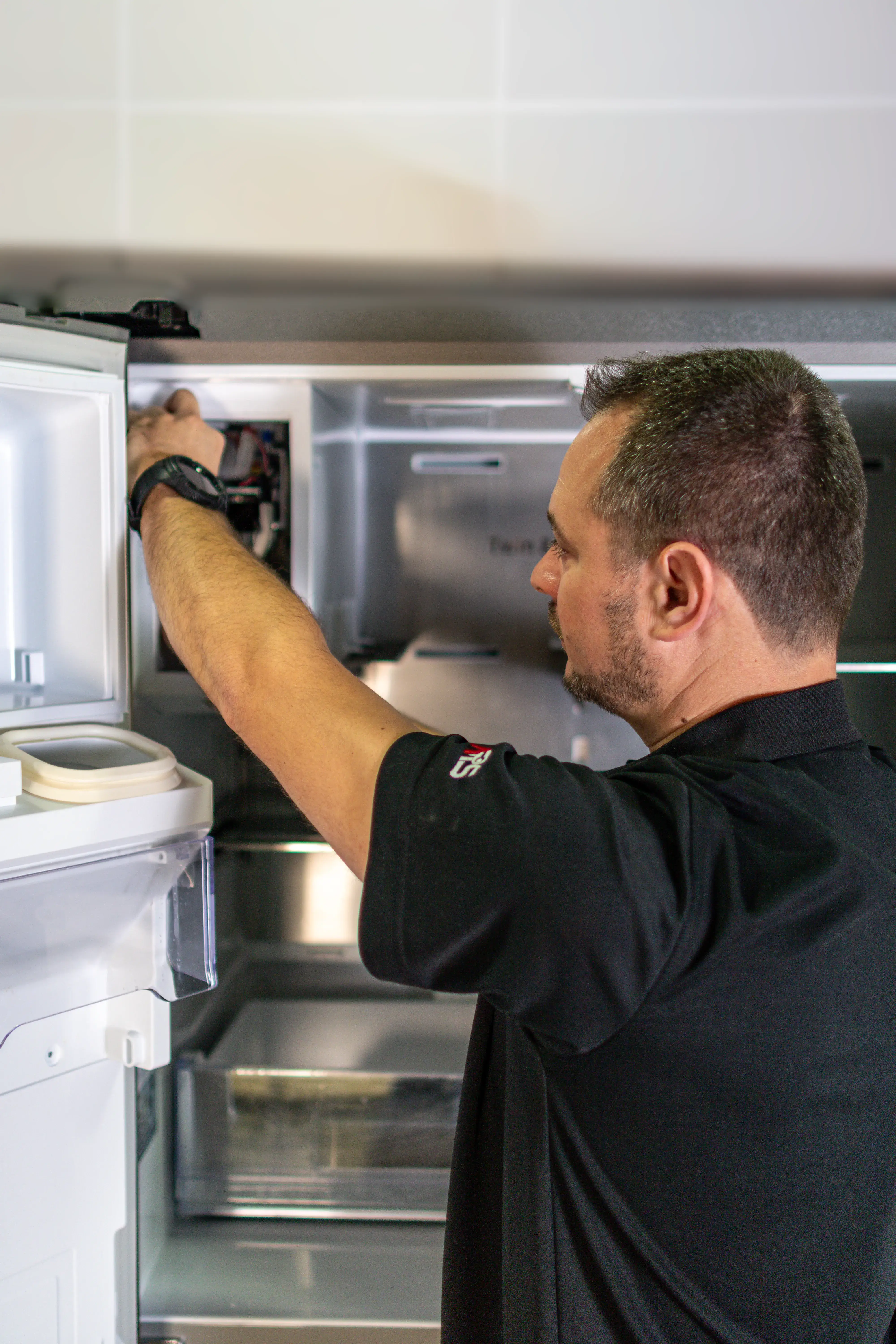 Refrigerator Repair Technician Fixing Ice Maker Refrigerator Repair Technician Fixing Ice Maker